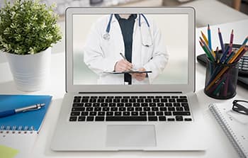 Eye Doctor on laptop during telehealth appointment